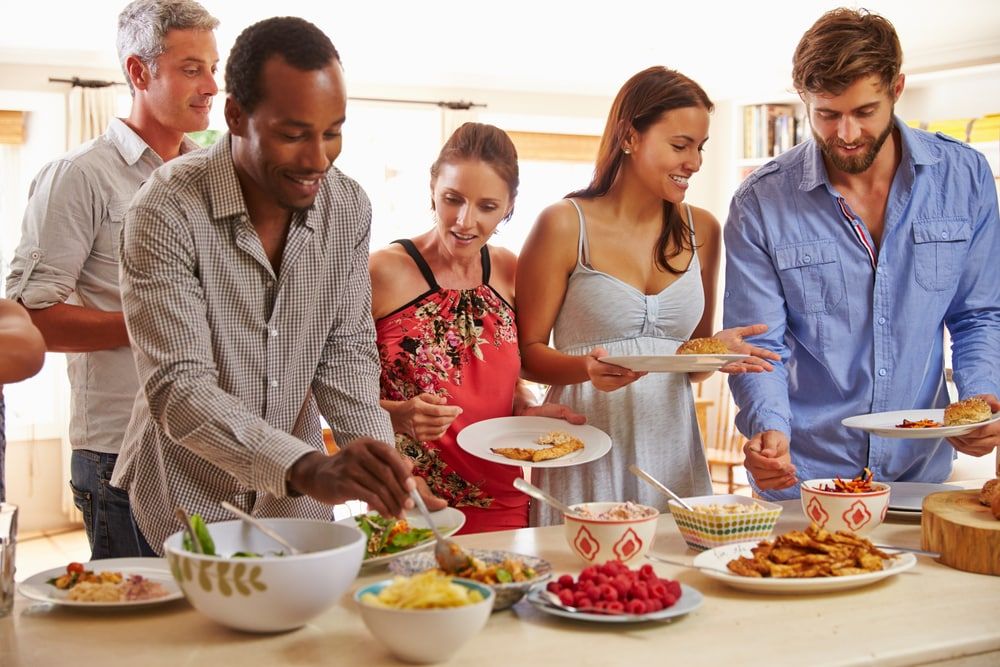 serving food in kitchen with friends Serving Food in Kitchen