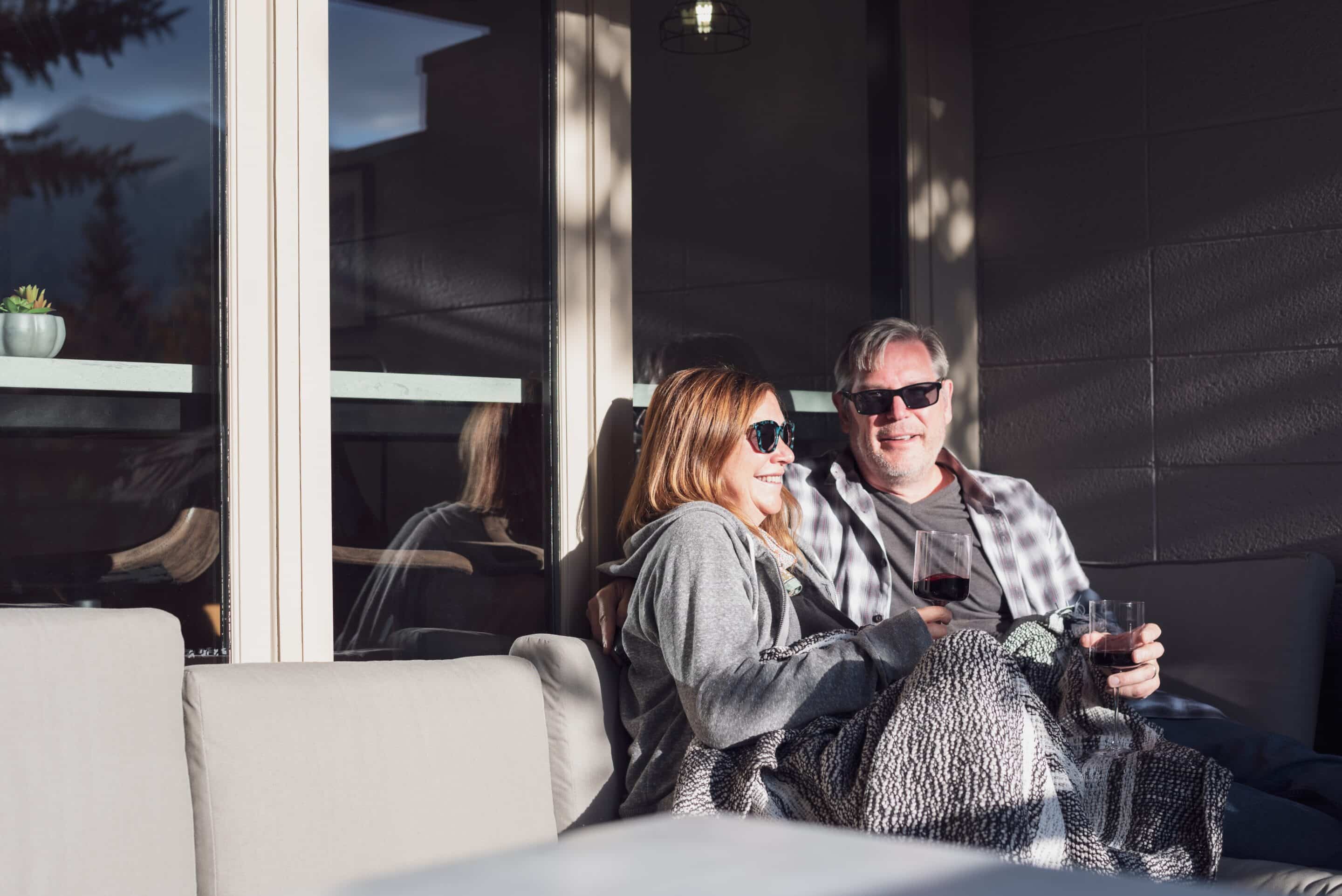 Happy,Middle,Aged,Couple,Snuggled,Up,In,A,Blanket,Sitting Remodeling Needs for Empty Nester People