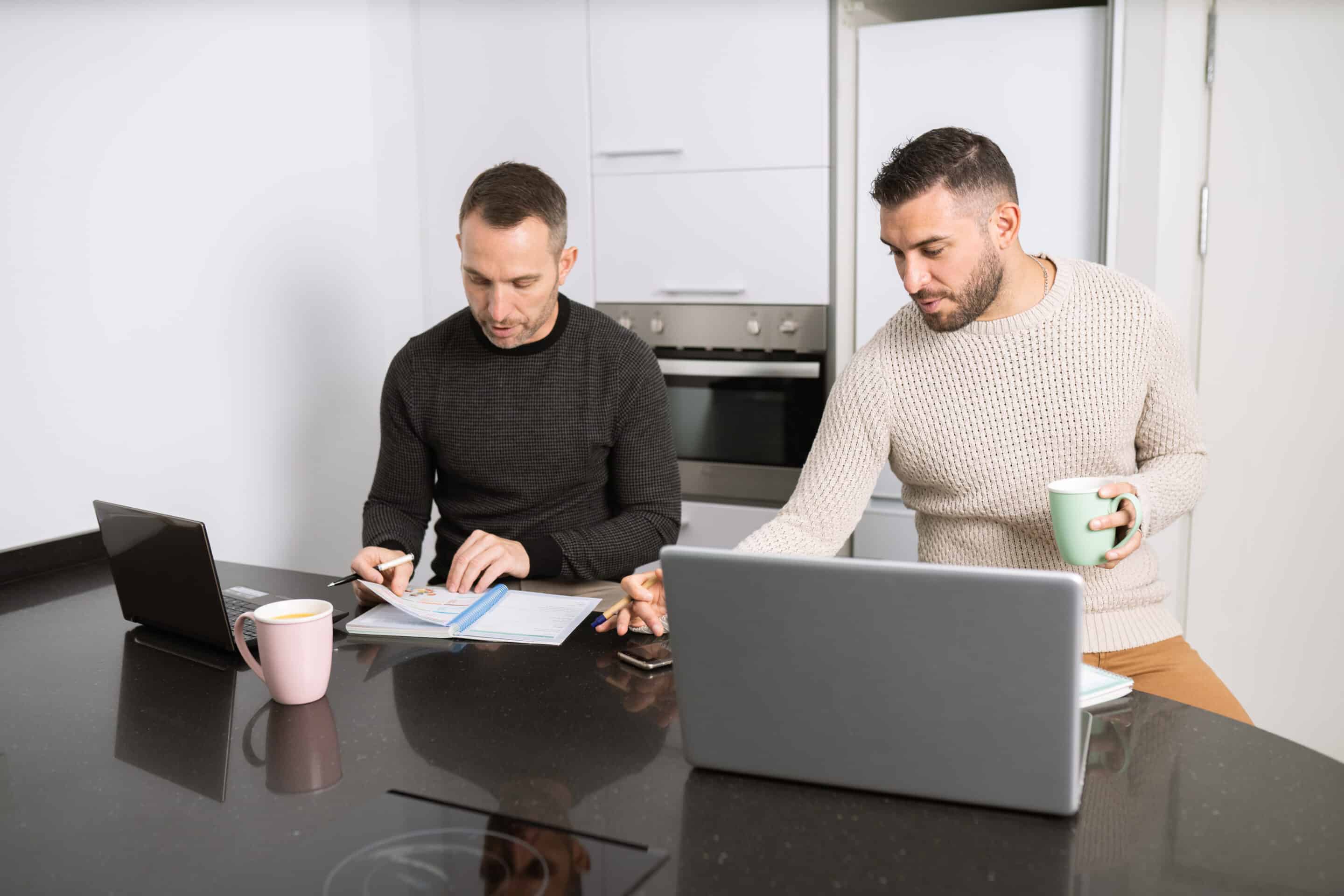 Gay,Couple,Working,Together,At,Home,With,Their,Laptops.,Lifestyle Busy Couple People
