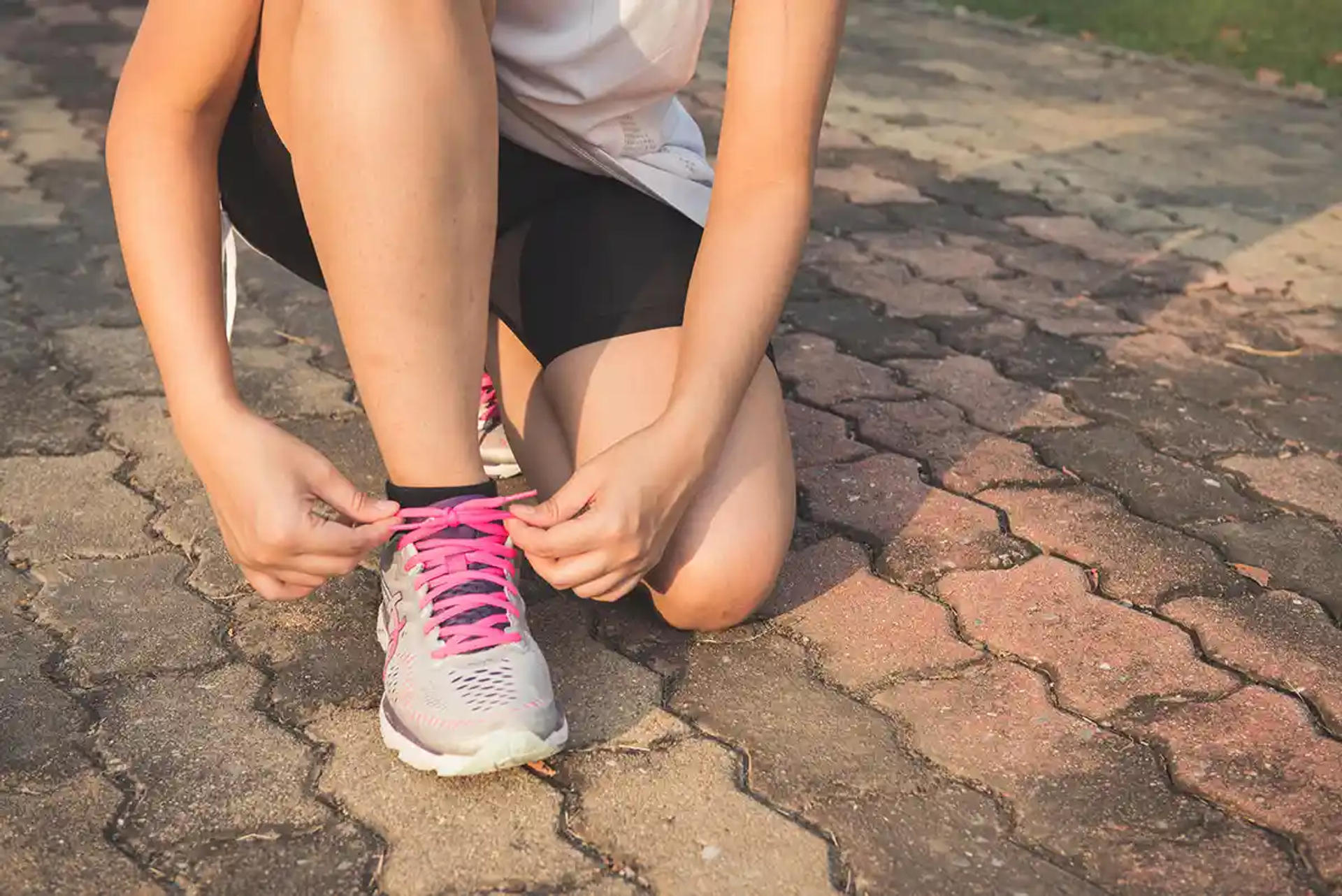 Woman putting on her running shoes