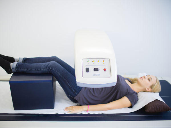 Woman inside a DEXA scannner