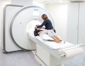 Nurse preparing a woman to get an MRI