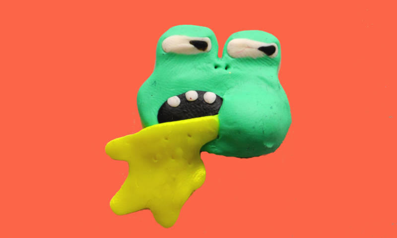 Photo of a sculpted comic frog communicating disgust