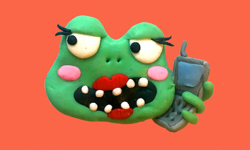 Photo of a sculpted comic frog communicating language