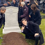 Guy posing in front of grave