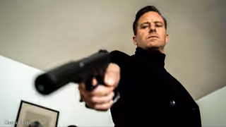Armie Hammer Pointing a Gun
