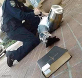 Arrested crusader reaching for book