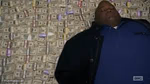 Black guy lying on money