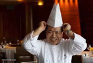 Excited Chef Adjusting Hat