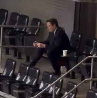 Elon Musk Using Mobile in an Empty Stadium