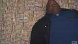 Fat guy laying on money
