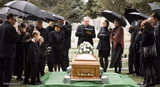 Mourners Around Casket Outdoors