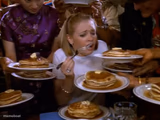 Girl being fed pancakes