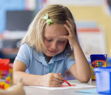 Girl crying while drawing