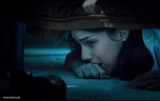 girl hiding under bed