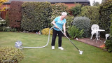 Grandma vacuuming yard