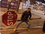 Guy holding stop sign