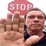 guy in front of stop sign