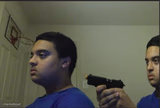 guy pointing gun at self