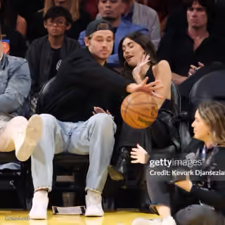 Justin Herbert Protecting Madison Beer at the Lakers Game
