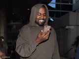 kanye smiling at phone