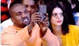 Kanye taking a picture
