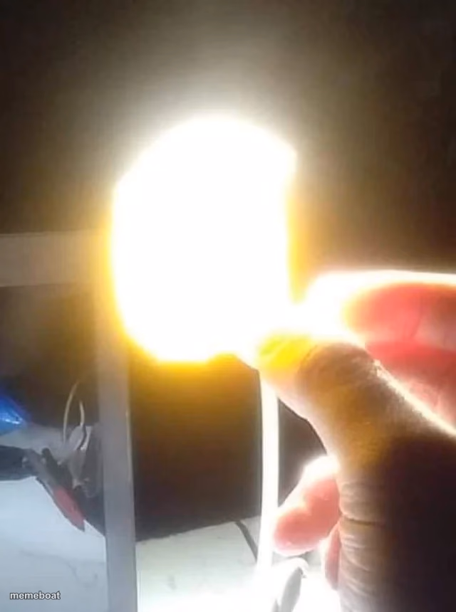 Man Holding Glowing Chip - meme generator image preview