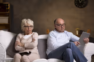 Old Couple On Couch Angry