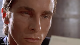 Patrick Bateman staring at card
