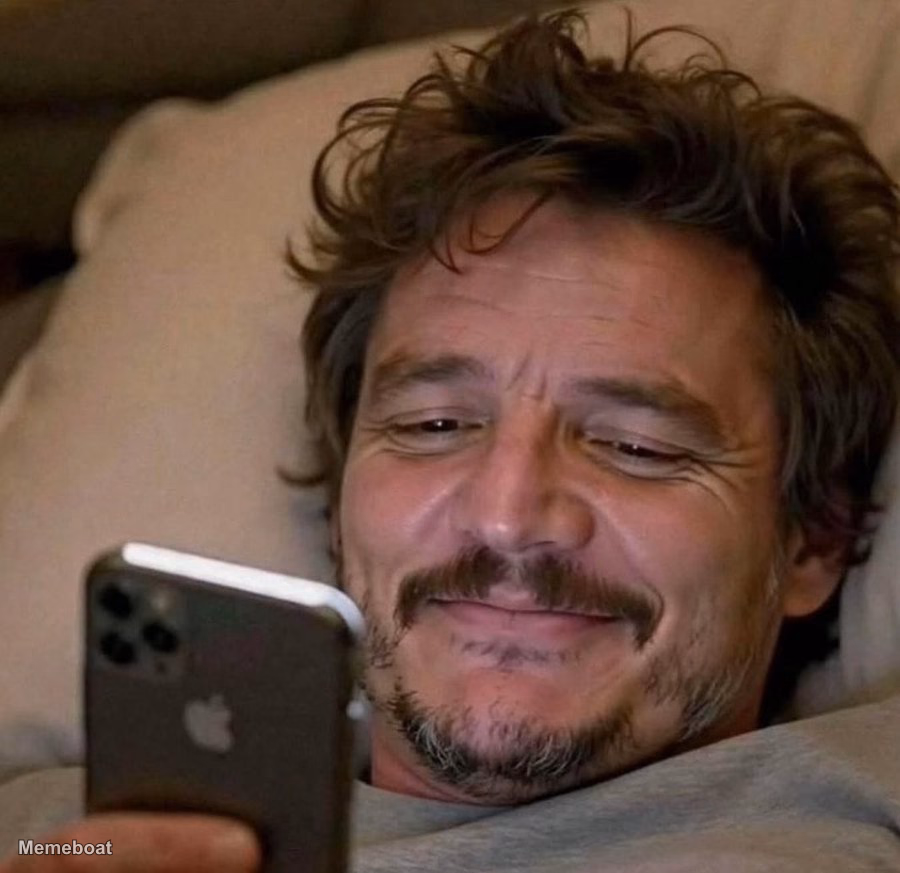 Pedro Pascal Smiling at Phone - meme generator image preview