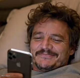 Pedro Pascal Smiling at Phone