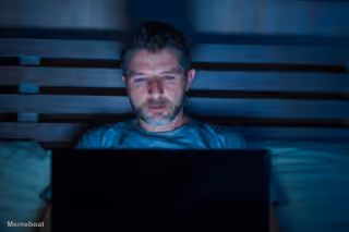 Person Glued to a Laptop in Bed at Night