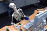 Skeleton at desk/computer/work