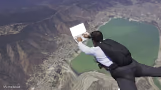 Skydiver Working on Laptop