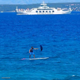 Guy Flying Kite On Paddleboard