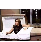 WOMAN CLIMBS OUT OF COFFIN