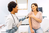 Woman giving woman a shot