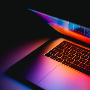 Open MacBook with glowing screen