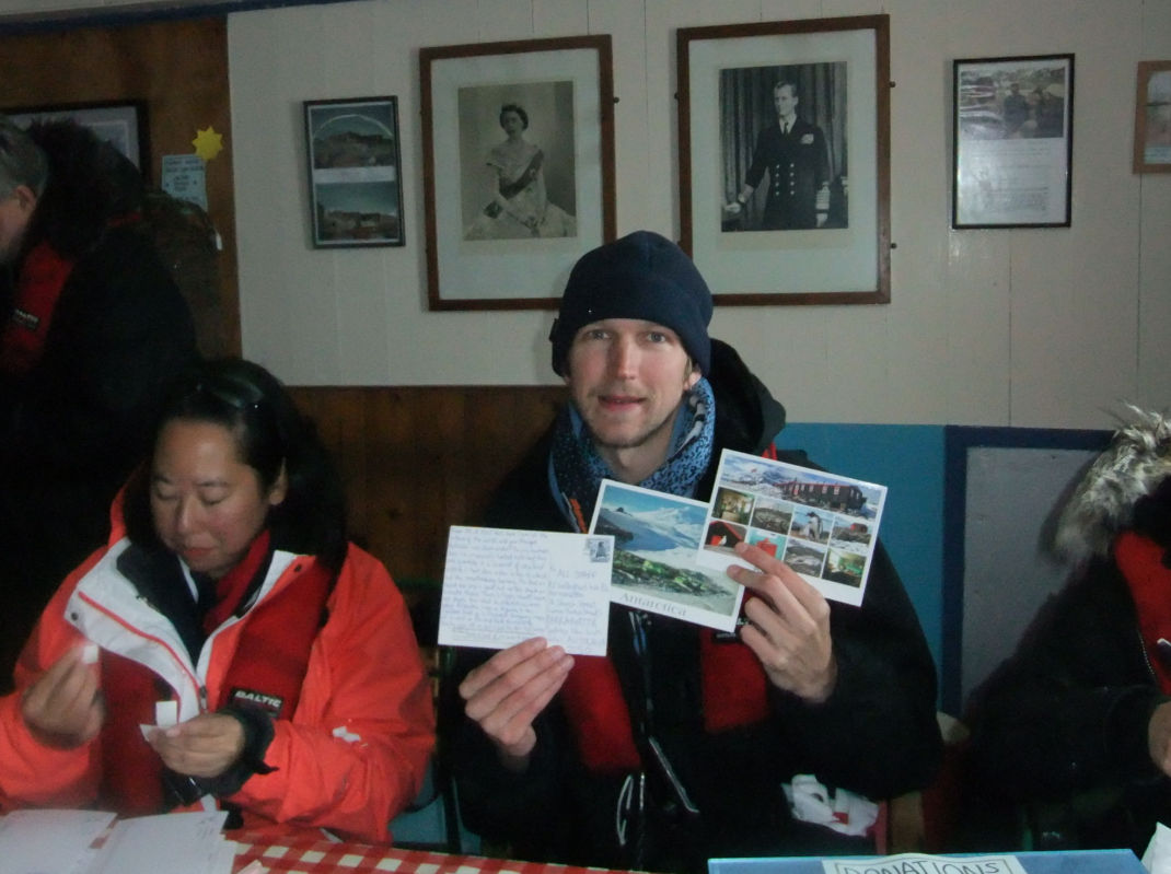 A man showing his Post cards from Antarctica