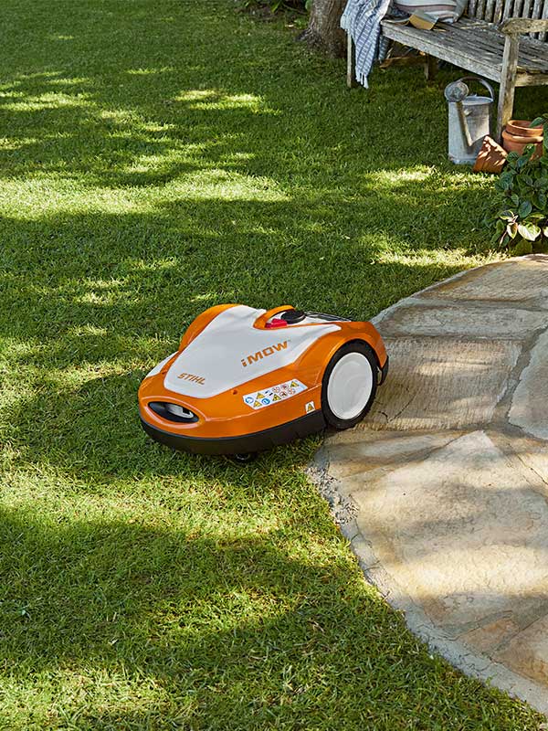 the iMOW® RMI 522 C robotic mowers cuts the lawn along the pathway