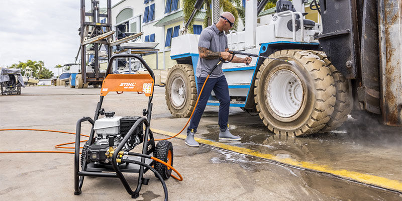 Man using STIHL RB 600 Petrol pressure washer to clean the wheels of his vehicle