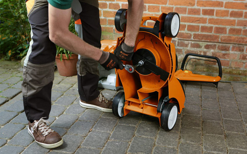 Battery Lawnmower tipped upside down to access the blade