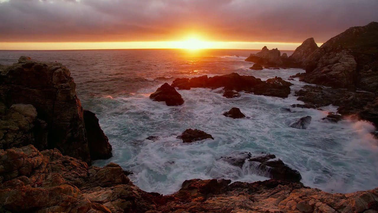 waves crashing at sunset