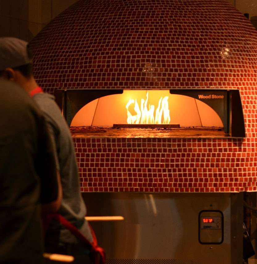 flaming_rustic_flats_red_tiled_pizza_oven_cooks_up_another_-833x854