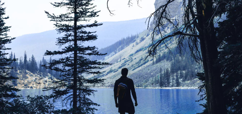 Man loking over lake at mountains