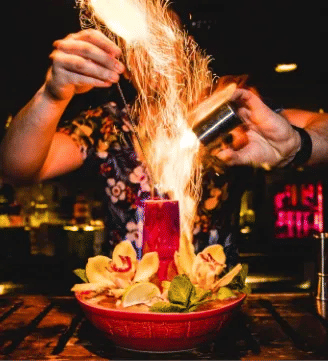 Person making a flaming cocktail