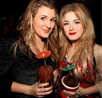 People holding cocktails at an event