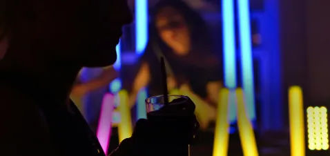 Person holding a drink at an event