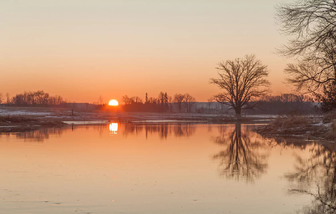 Sunset over lake to represent Midnight Sun