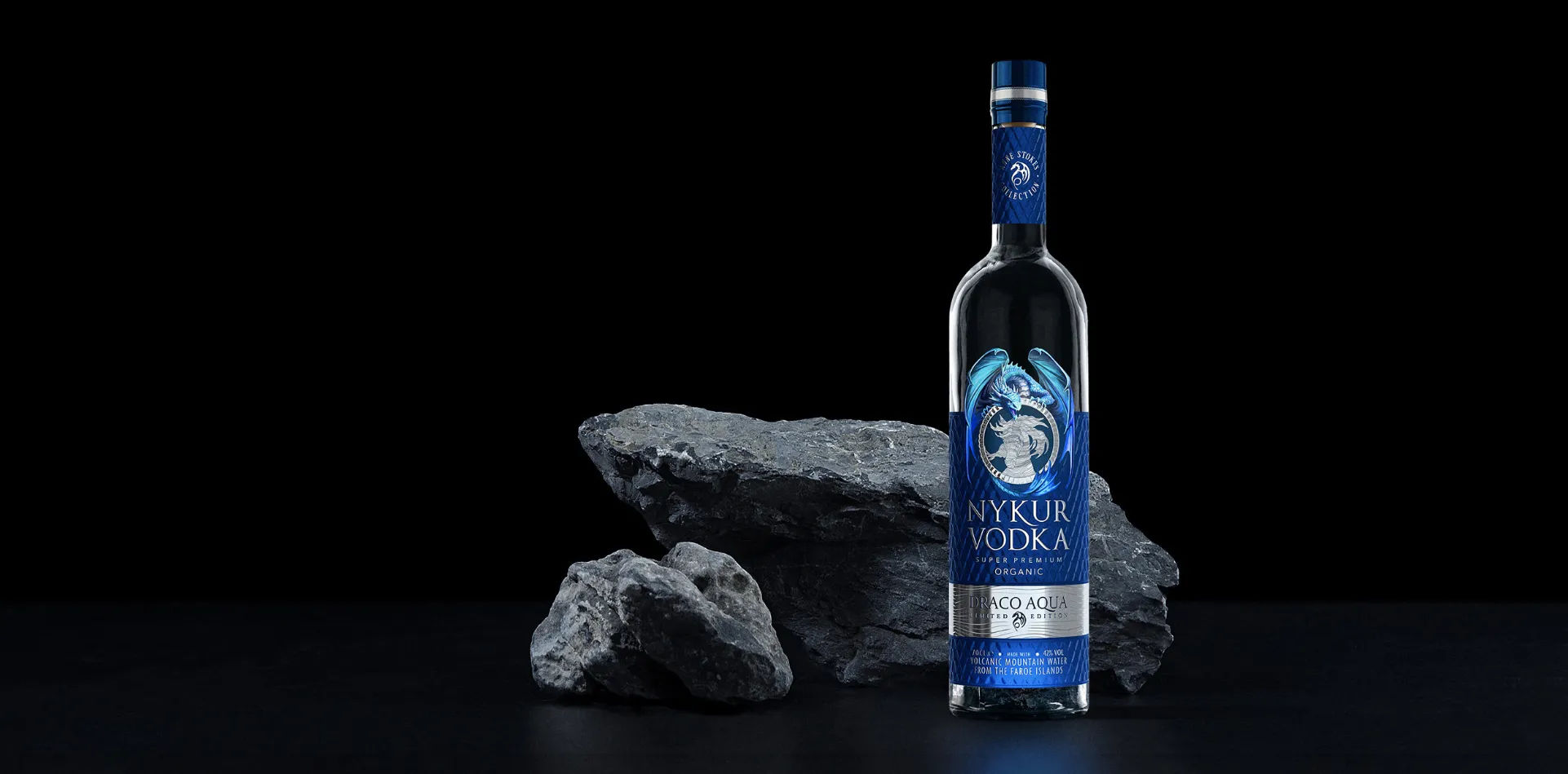 Nykur Draco Aqua vodka bottle in front of rocks